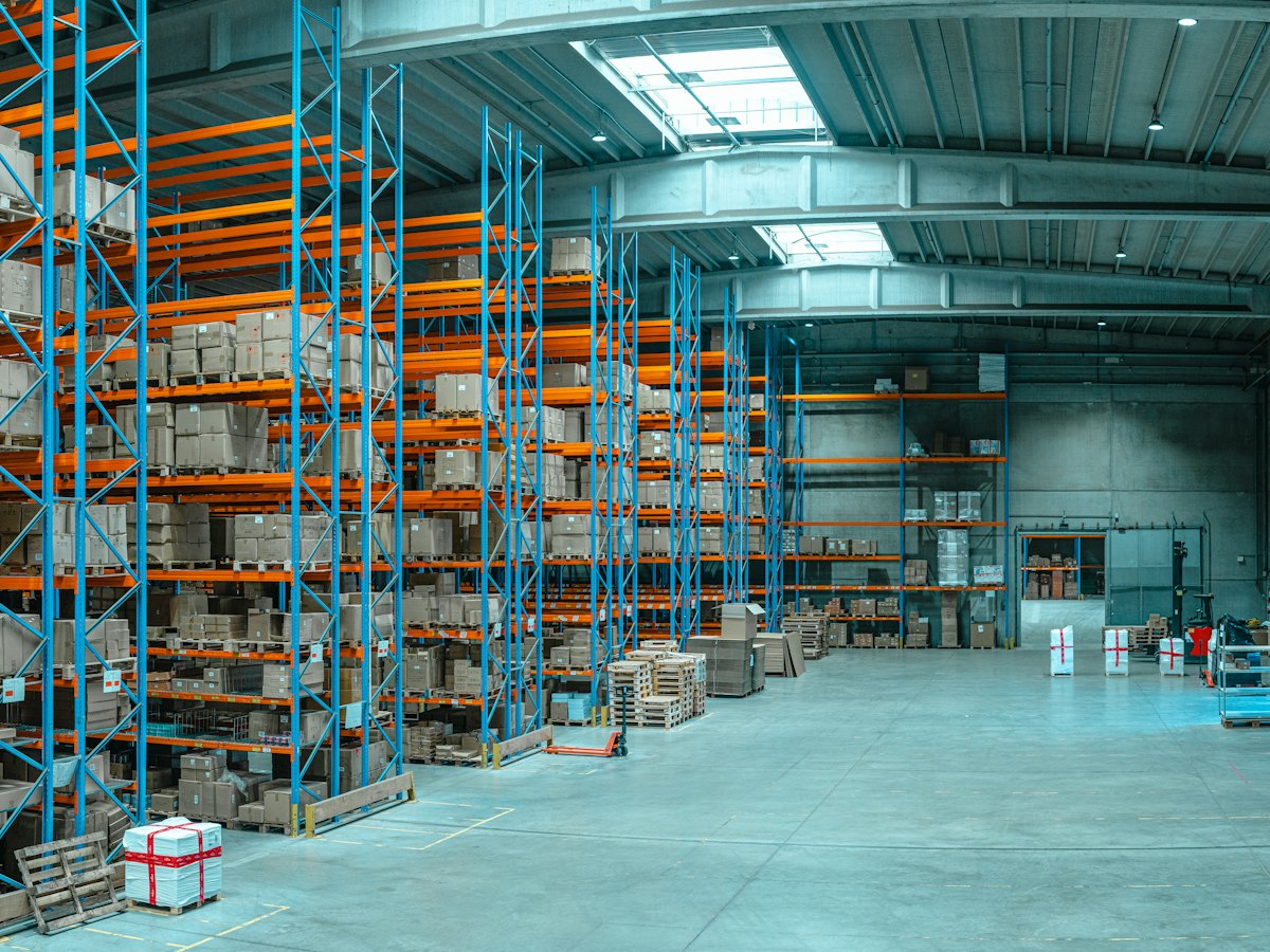 Warehouse aisle with palletised stock on high racking